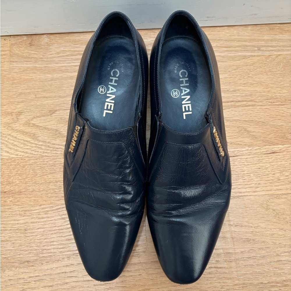 CHANEL Black Leather Slip-On Loafers with Gold Logo Accents